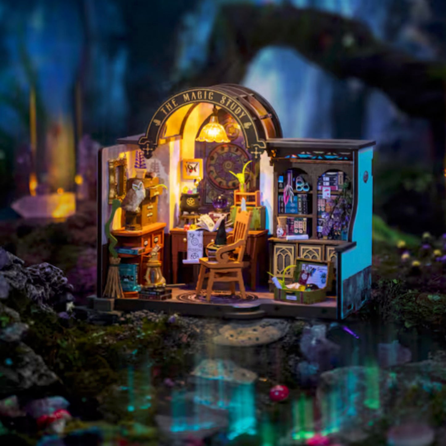A miniature model kit depicting a magical laboratory, filled with items for creating and casting spells. The kit is sitting on a rock in a magical forest. 