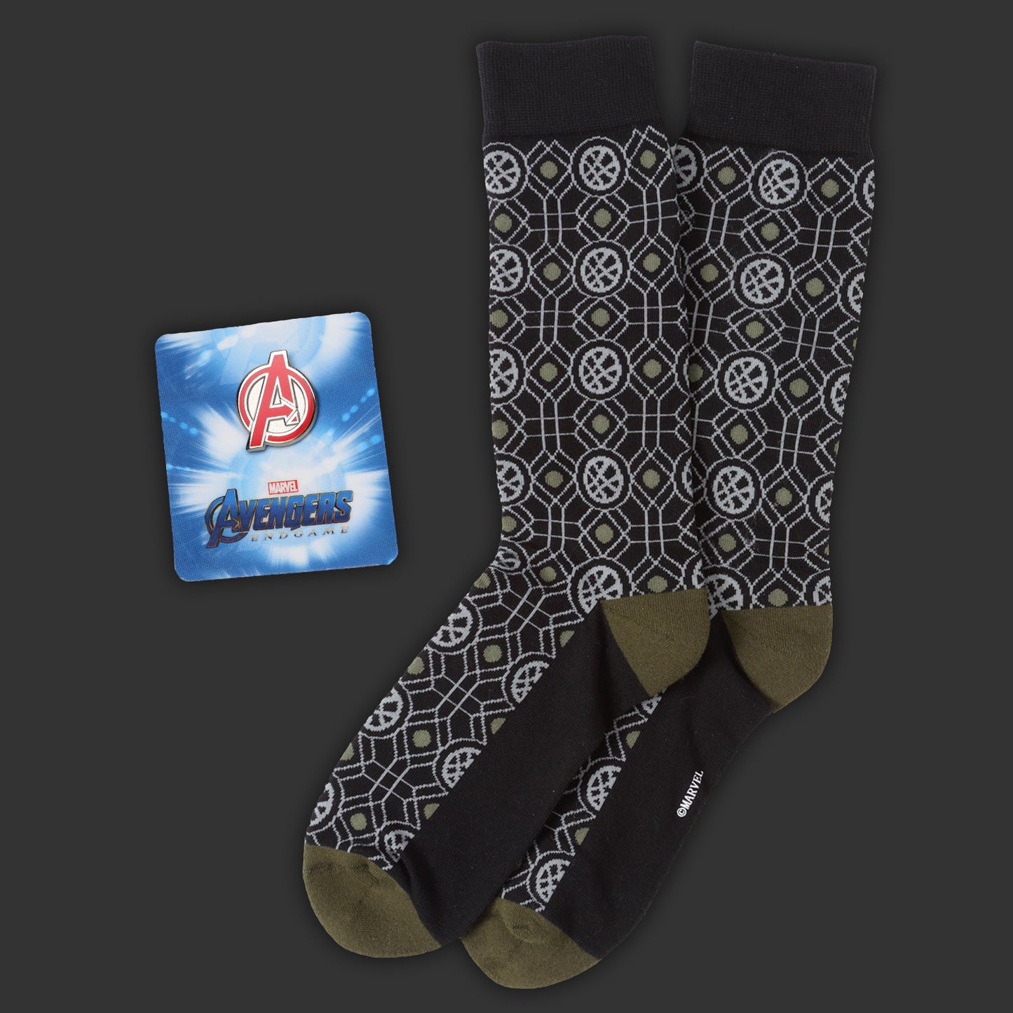 Patterned socks with a Marvel Avengers lapel pin on a dark background