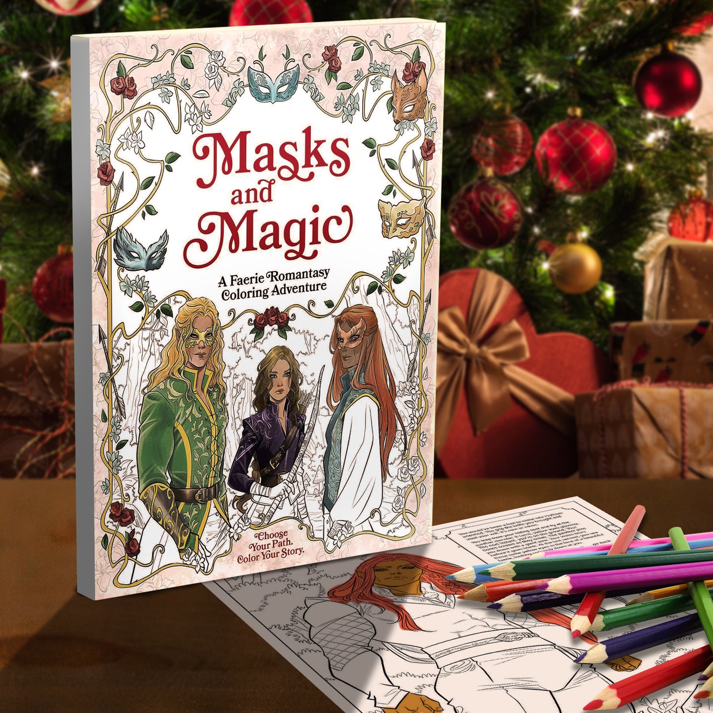 A coloring book on a table, with a Christmas tree in the background. The cover has drawings of faeries in masks, surrounded by vines. Text in the middle says Masks and Magic, a faerie romantasy coloring adventure. In front of the book is a page with colored pencils on top