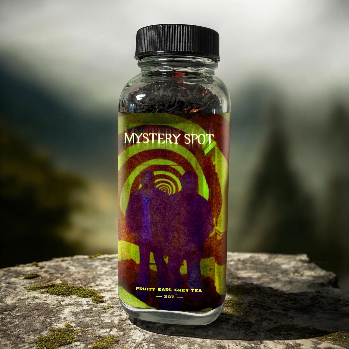 Bottle of 'Mystery Spot' fruity earl grey tea on a stone surface with a blurred natural background