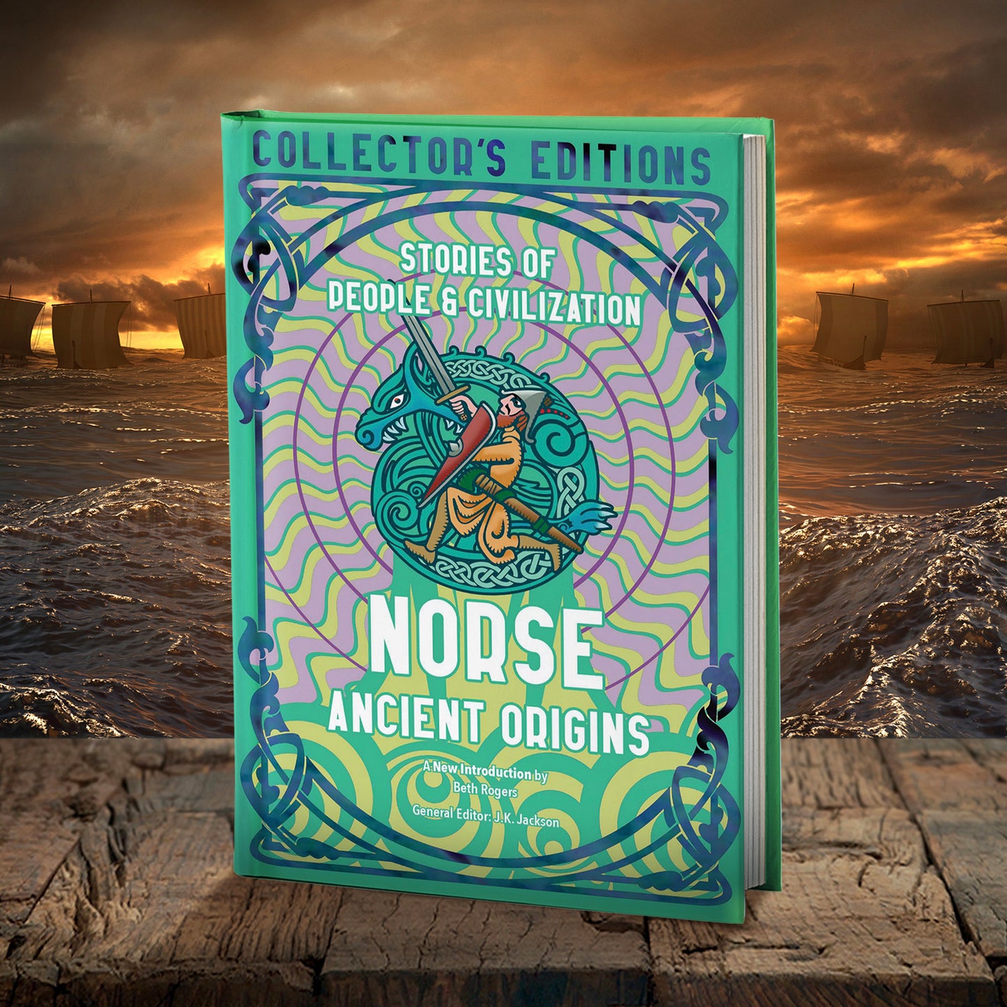 A copy of the book "Norse Ancient Origins: Stories of People & Civilization - Collector's Edition" by J.K. Jackson and Beth Rogers. The book is on a rough wooden table. In the back ground are Viking ships on the open sea, under an orange sky.