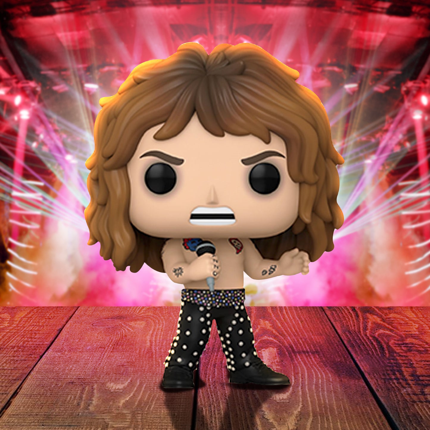 A vinyl Funko Pop figure depicting heavy metal icon Ozzy Osbourne, from 1989. He's wearing black pants with colored beads, and carrying a microphone. The figure is on a wooden stage, with a heavy metal concert in the background.