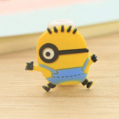 Close up view of a plastic phone charger clip, with a Minion from "Despicable Me" on the front.