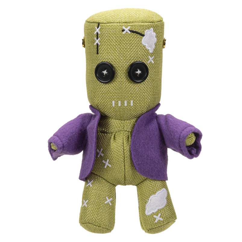 Green plush toy with a purple jacket on a white background