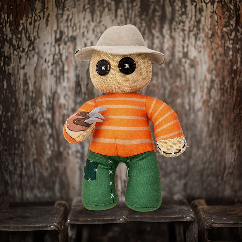 Toy figure with a hat, striped shirt, and green pants against a wooden background