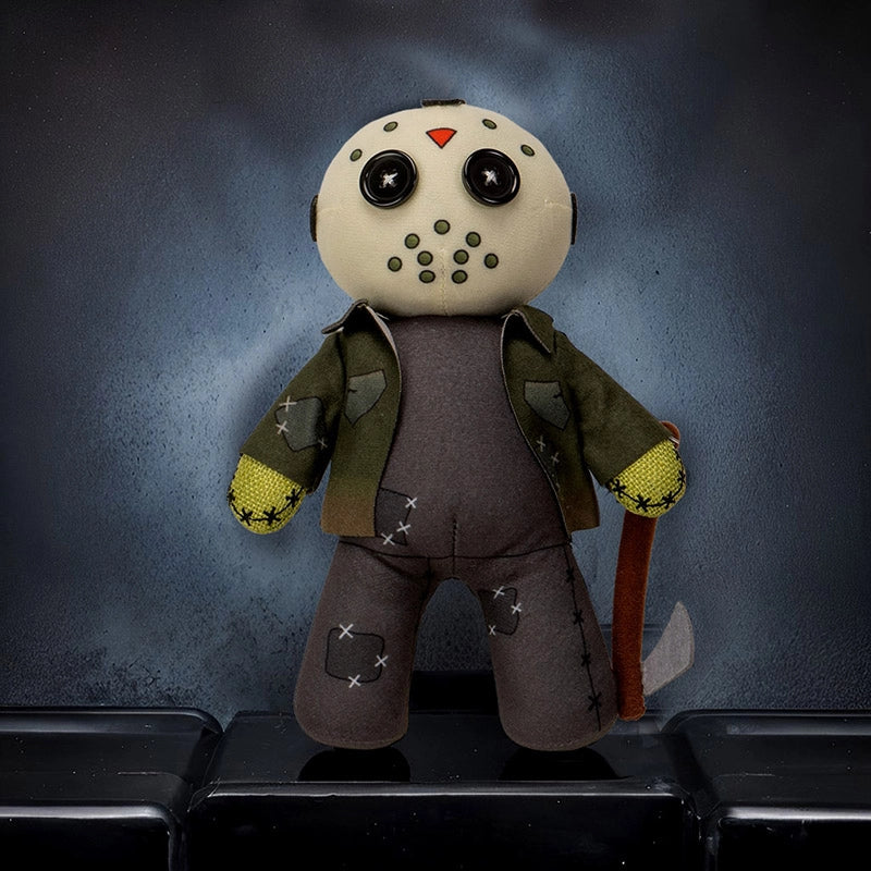 Plush toy resembling a character with a mask, green jacket, and axe on a dark background