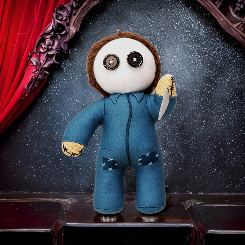 Stuffed toy figure in a blue outfit with star patterns on a dark background