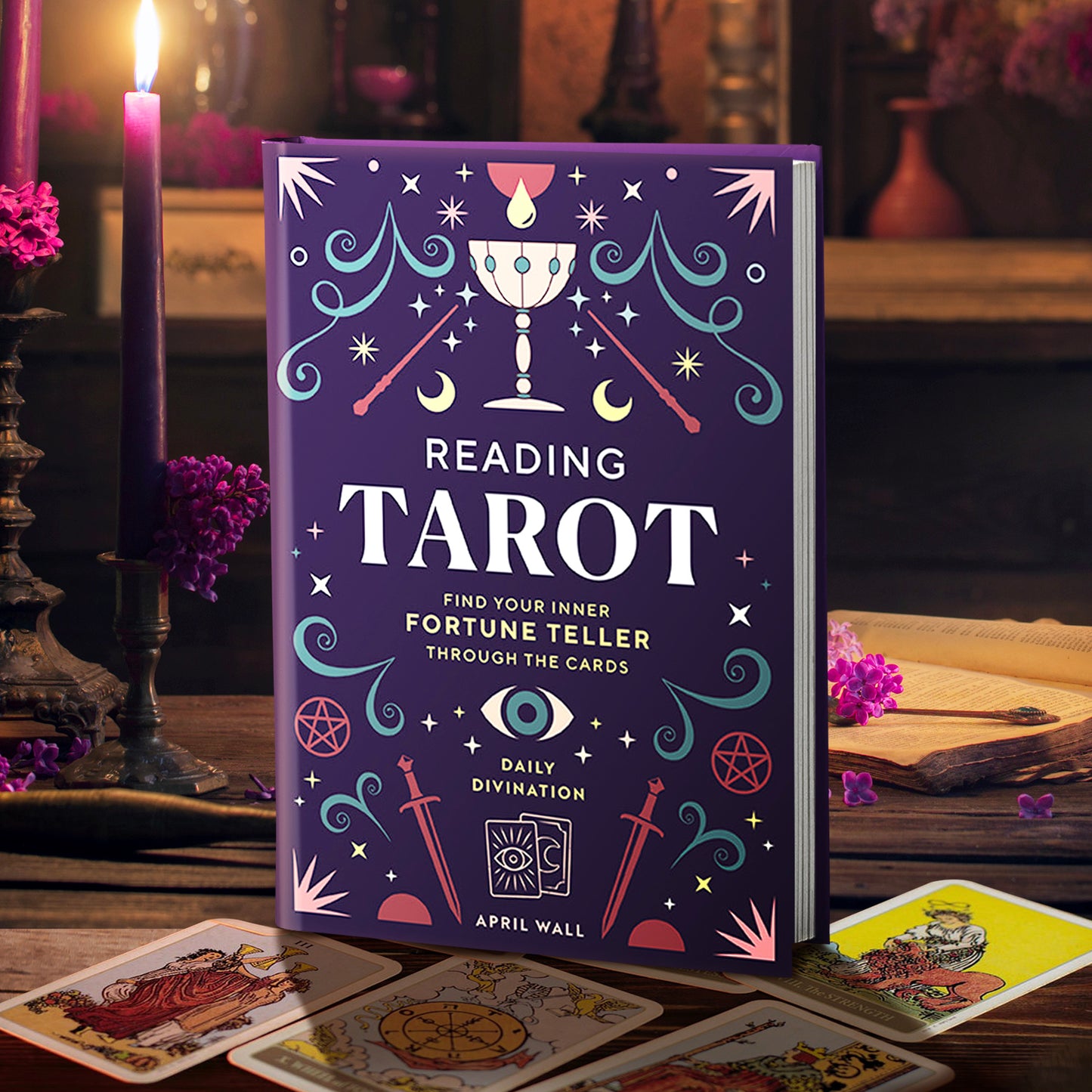 A tarot card deck book titled 'Reading Tarot' by April Wall stands upright on a wooden table, surrounded by lit candles, tarot cards, and a warm, atmospheric background.
