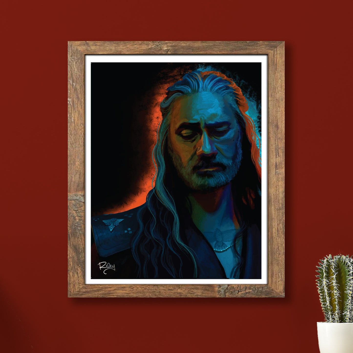 A framed lithograph on a red wall. The lithograph depicts the character Ed from Our Flag Means Death.