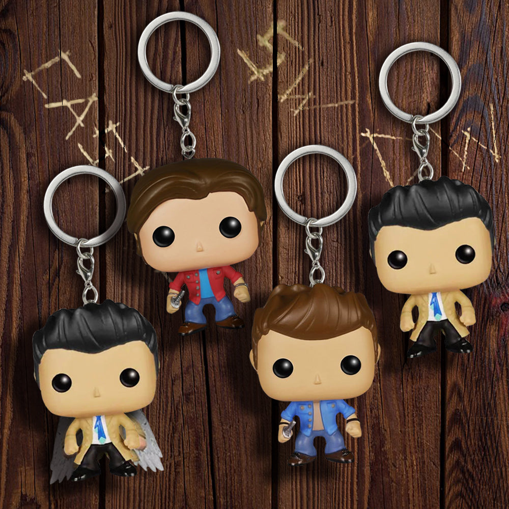 An array of 4 Supernatural "POP" figures on silver keychains. Shown are Castiel in his default outfit with black wings, Sam Winchester in a red shirt, Dean Winchester in a blue shirt, and a default Castiel in the same outfit with no wings.