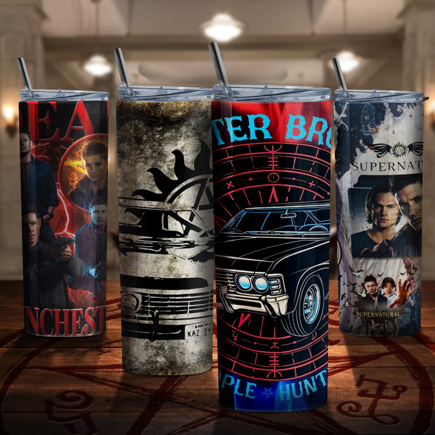 Four tumblers on a wooden table, inside the SPN "bunker." Each tumbler depicts characters and images from the TV series Supernatural.