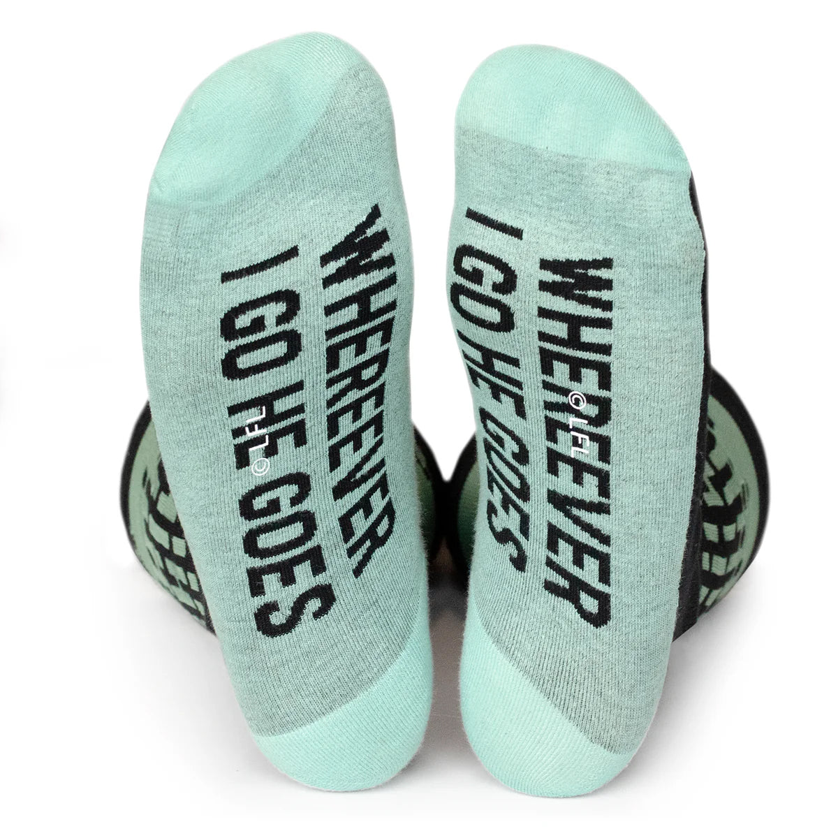 Pair of socks with text 'WHEREVER I GO HE GOES' on a white background