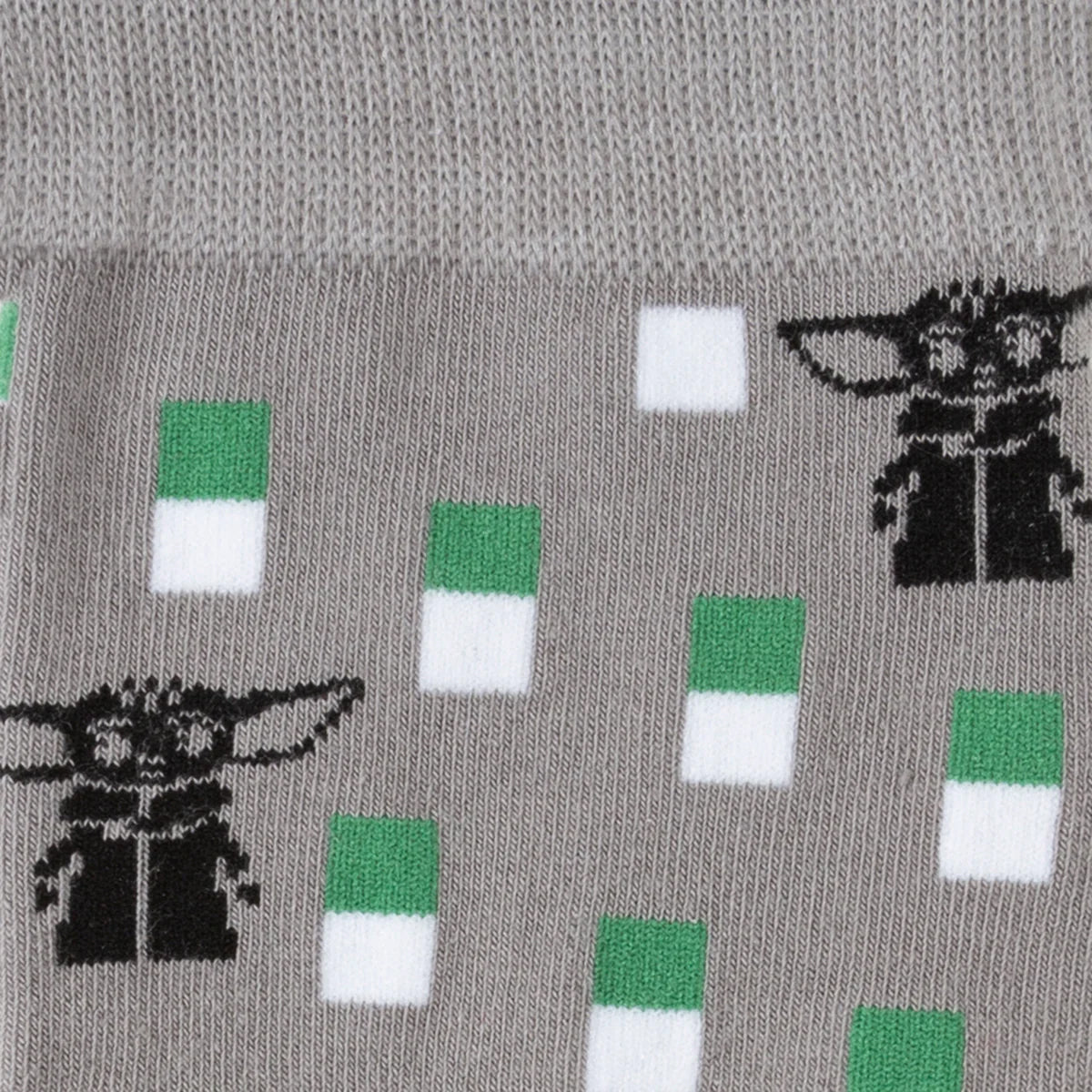 Gray sock with green and white pattern featuring Grogu