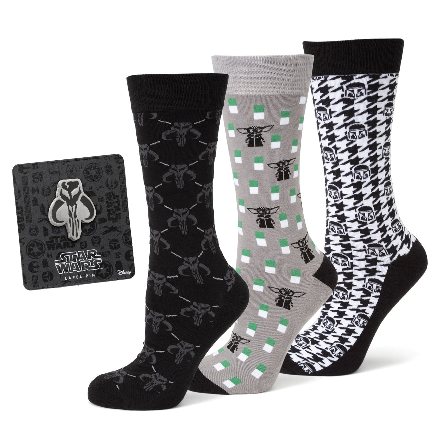 Three pairs of Mandalorian-themed socks on a white background. Next to them is a Mandalorian pin on a black cardboard backing.