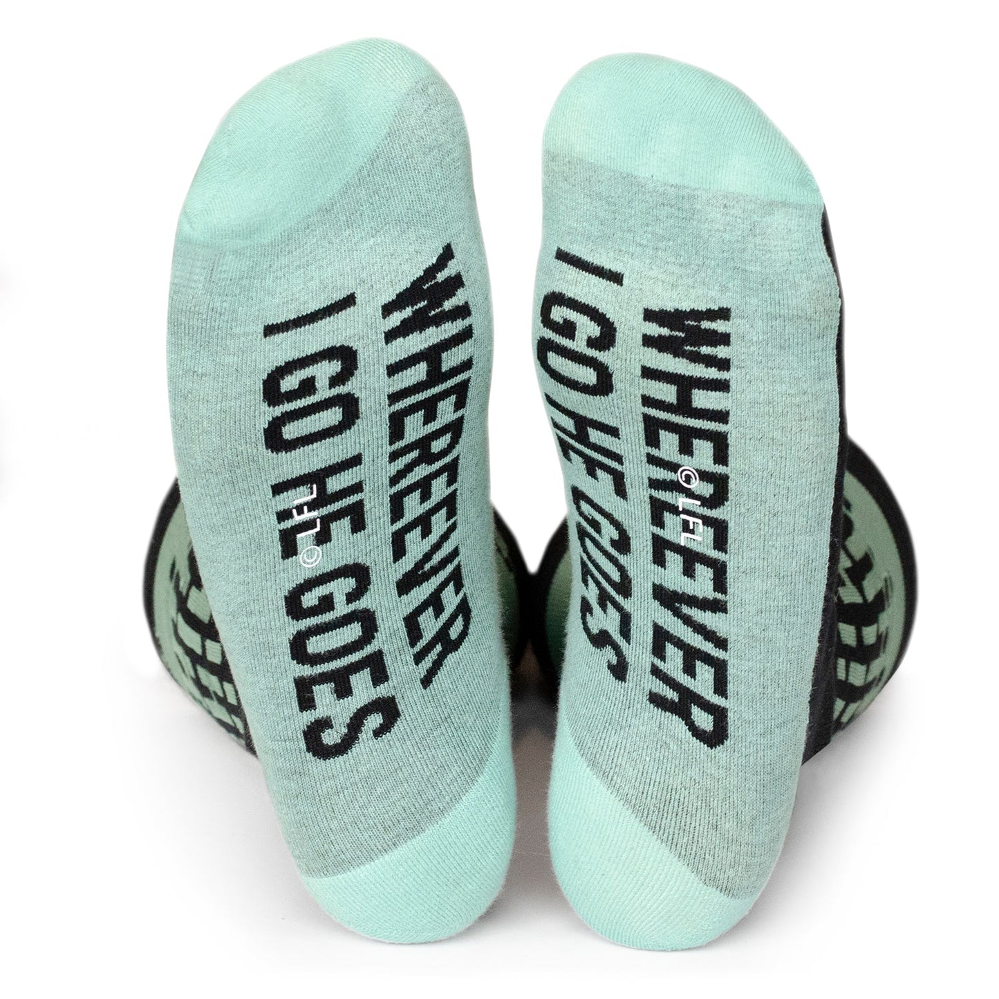 Pair of socks with text 'WHEREVER I GO HE GOES' on a white background