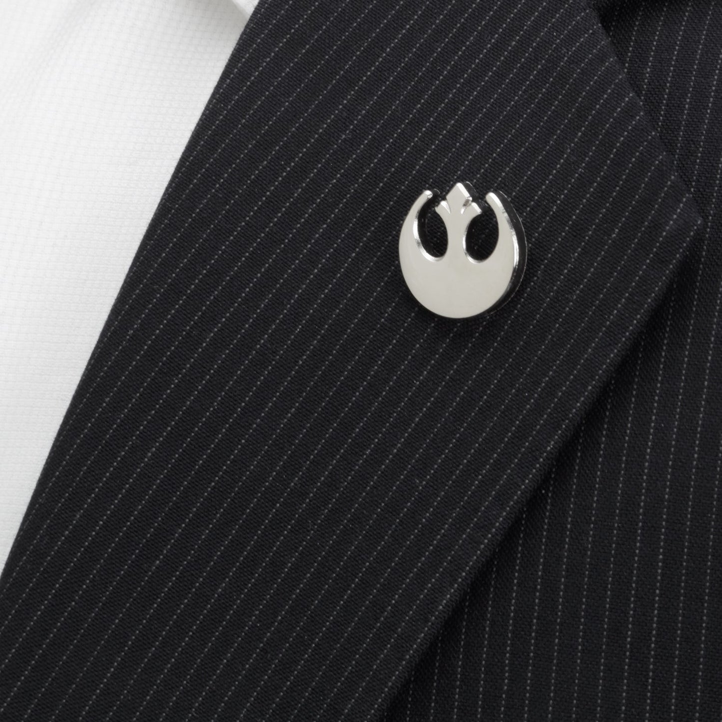 Silver Rebel Alliance symbol lapel pin on a black pinstripe suit