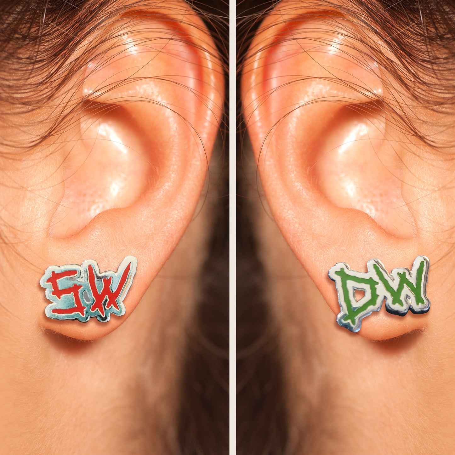 Close up of two model's ears side by side, each wearing an earring. The left earring depicts the initials SW in red. The right earring depicts the initials DW in green.