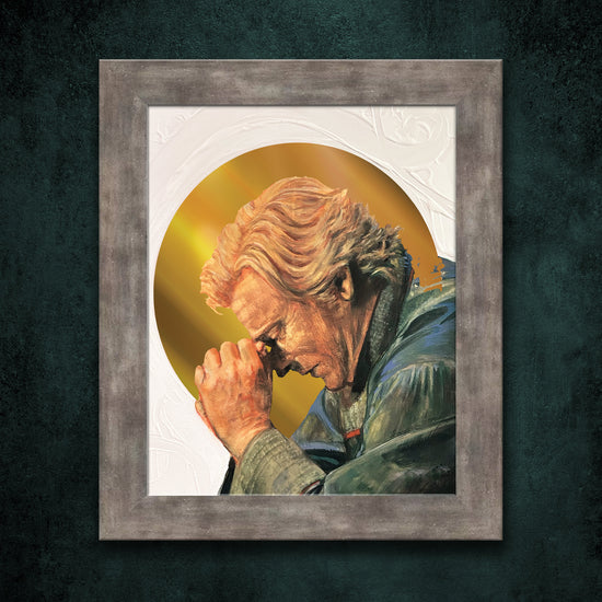 A framed lithograph against a green background. The lithograph depicts the character Stede from the series "Our Flag Means Death." Stede is leaning forward, with his head resting on his hands. A gold halo surrounds him.