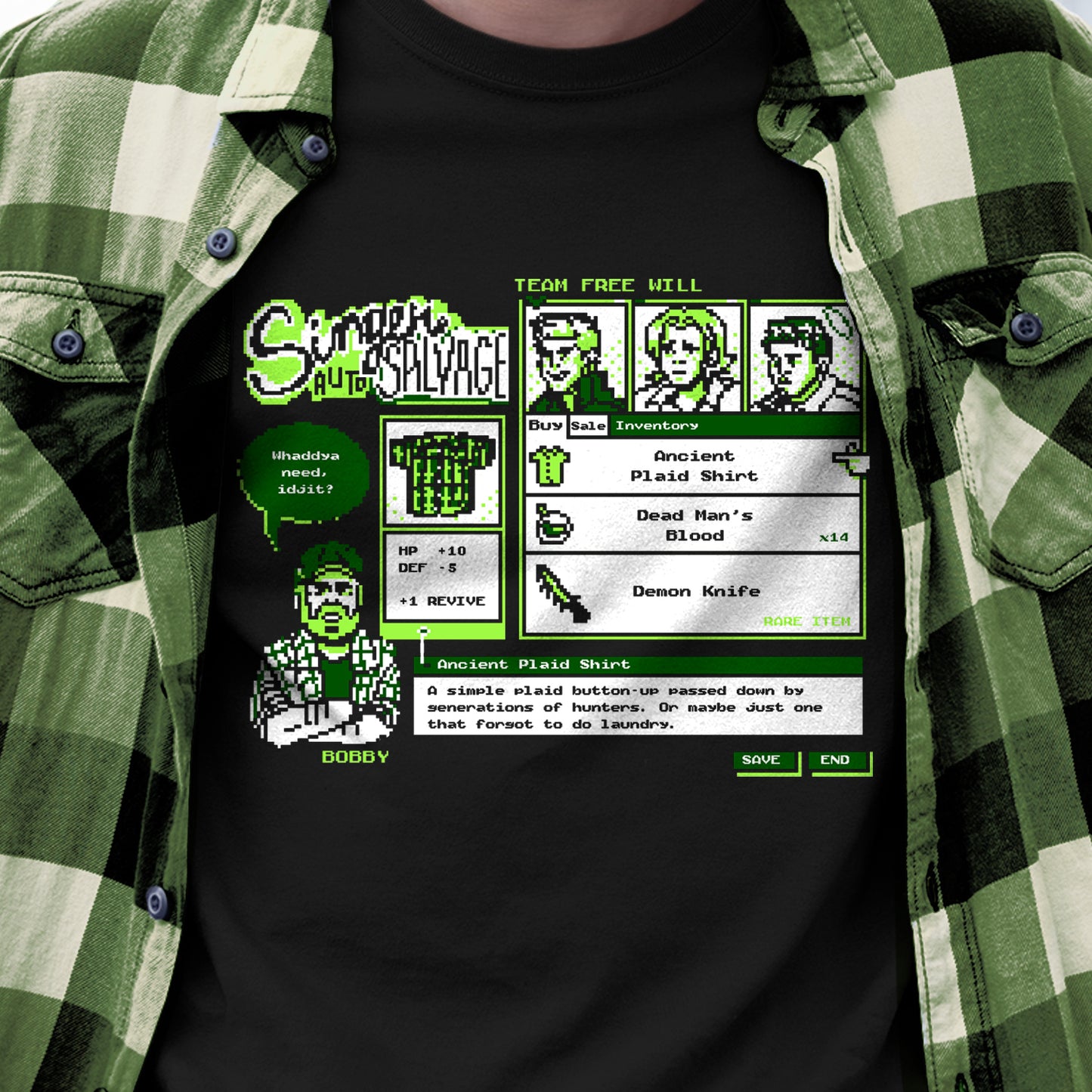 A black graphic t-shirt featuring a retro video game interface design for 'Singer Auto Salvage' with green and white pixel art and text, worn by a person in a green and white plaid flannel shirt.