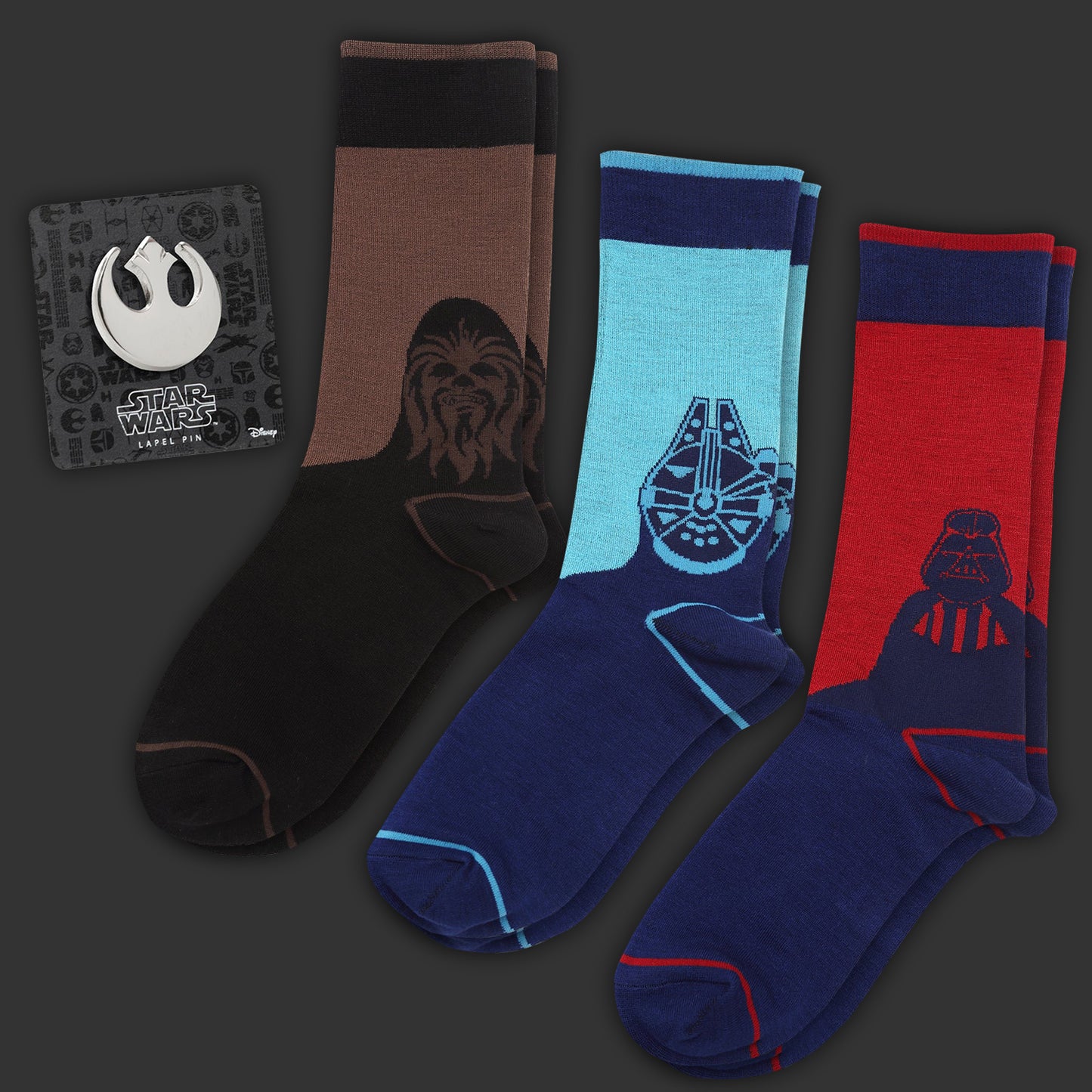 Set of Star Wars-themed socks with character designs on a dark background. Next to the socks is a silver lapel pin depicting the Rebel Alliance symbol