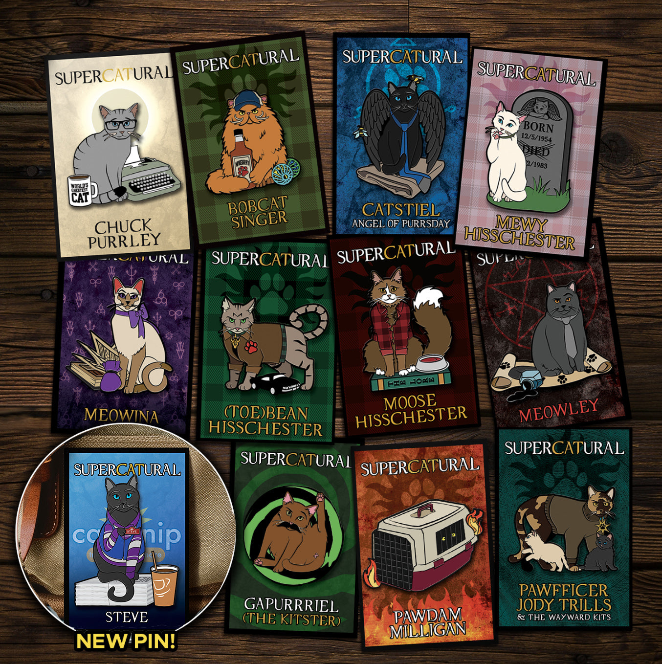 A collection of enamel pins on a wooden table. Each pin depicts a character from the TV series "Supernatural" reimagined as cats. An inset in the bottom left corner reads "NEW PIN!" and has an image of Steve, the newest pin.