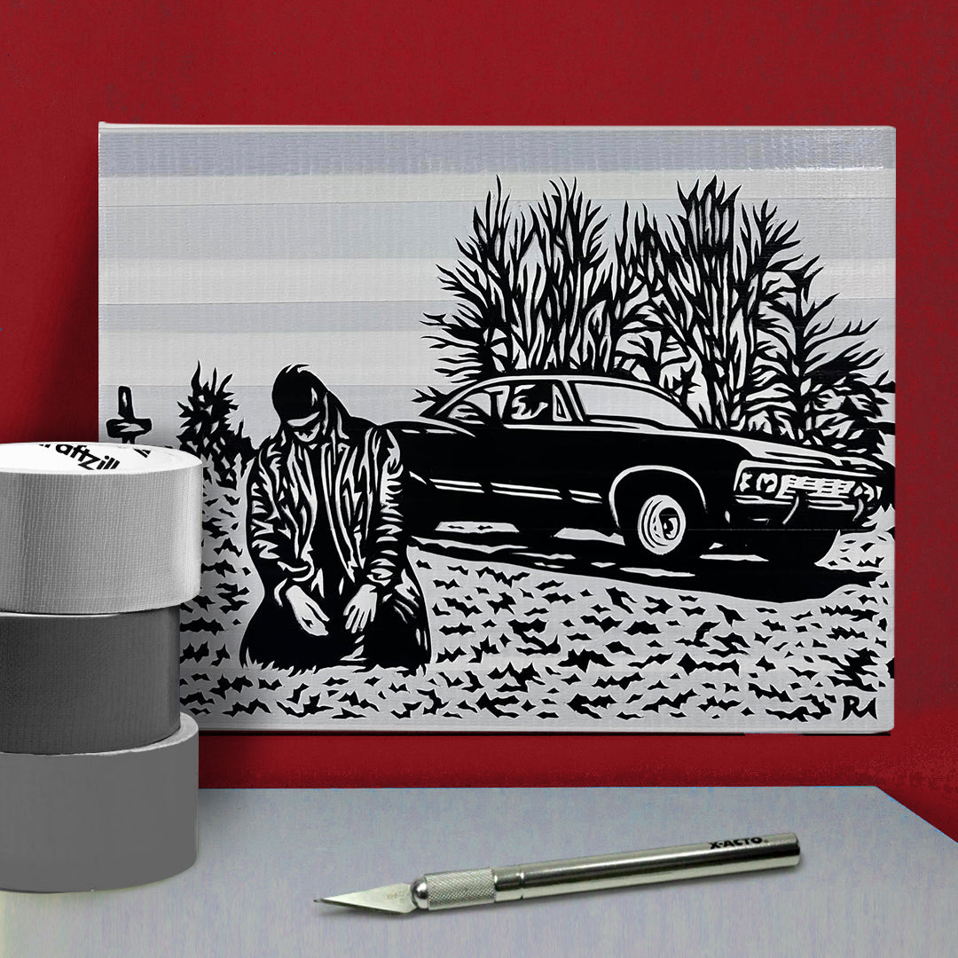 A grey and black poster against a red wall. The poster depicts Dean Winchester kneeling in a graveyard, in front of a grave. In the background is a black Chevy Impala. The poster is made of layered pieces of duct tape. In front of the poster is an X-acto knife and rolls of duct tape