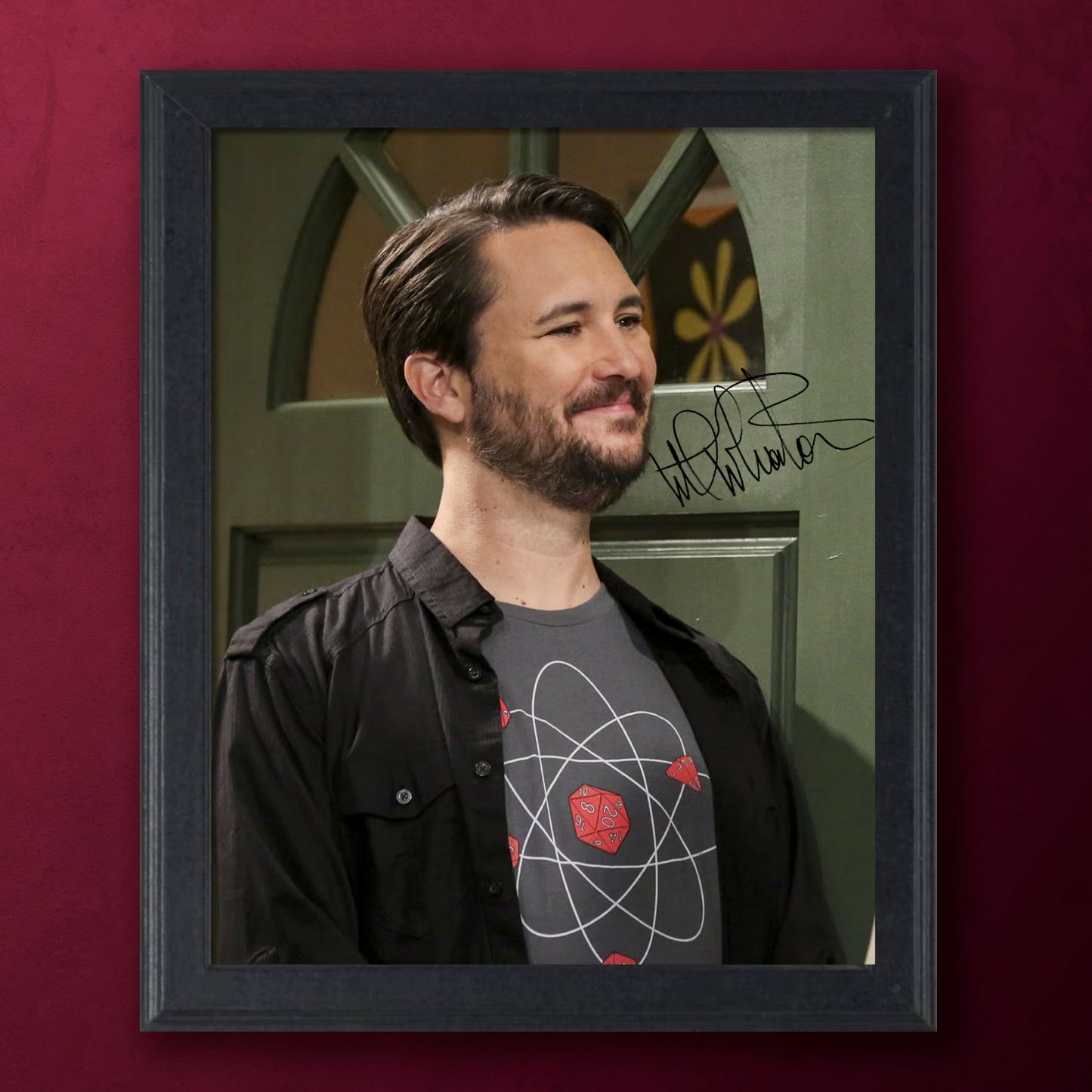 Framed portrait of actor Wil Wheaton in The Big Bang Theory with a signature on a red background