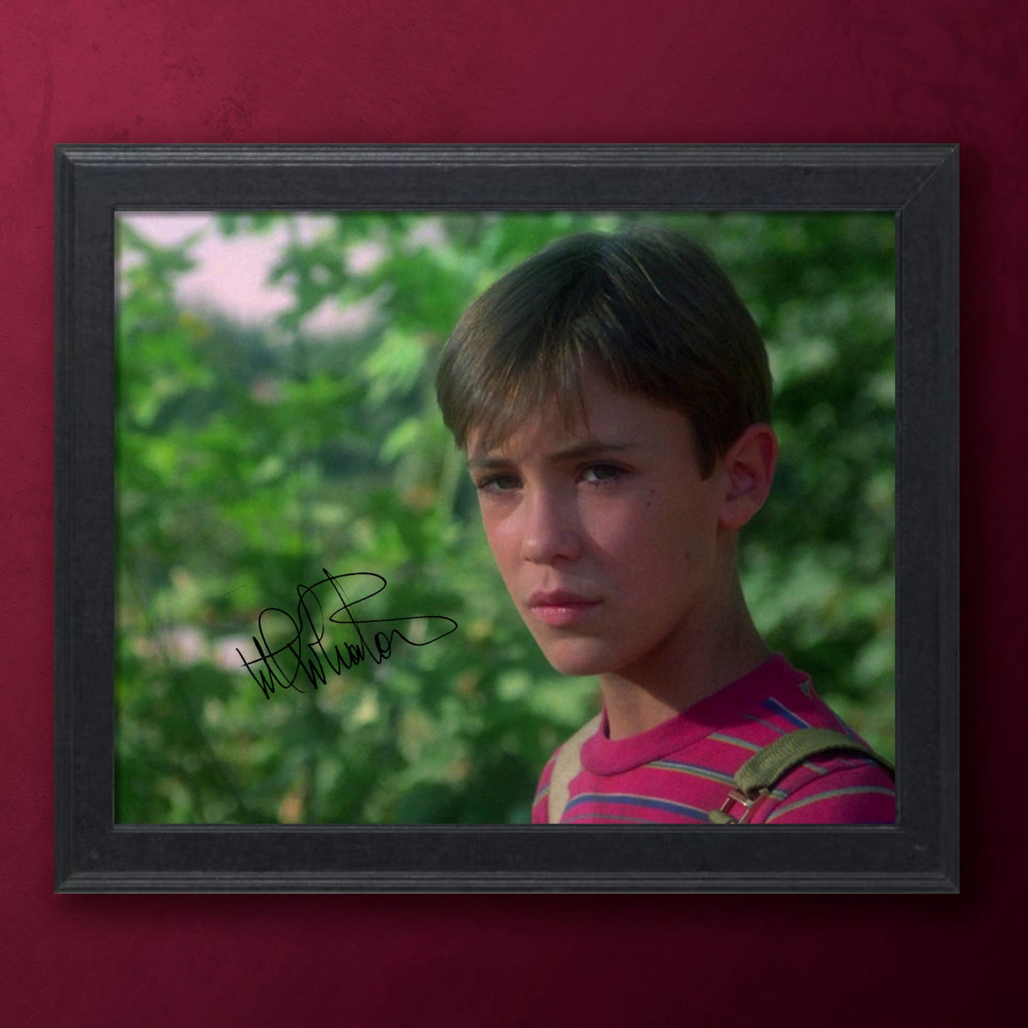 Framed photograph of actor Wil Wheaton in Stand By Me on a red background