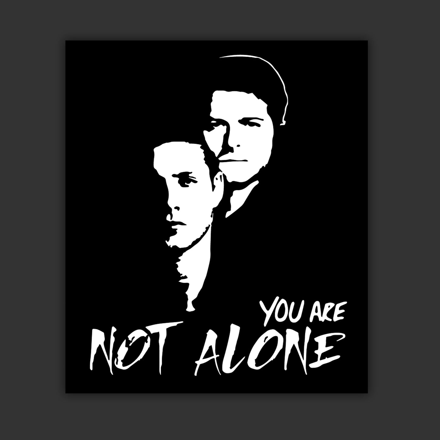 A vinyl sticker depicting a black and white drawing of the characters Dean Winchester and Castiel. White text says "You are not alone."