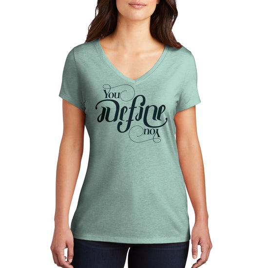 A female model wearing a sage green V-neck shirt with white text that says "you define you." The font is designed to look the same rightside up and upside down.