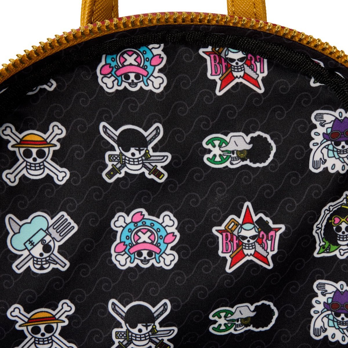 A close up view of the bag's interior. The background is a black fabric with light grey swirls in a pattern. Across the interior are cartoon drawings of a skull and crossbones flag in various costumes.