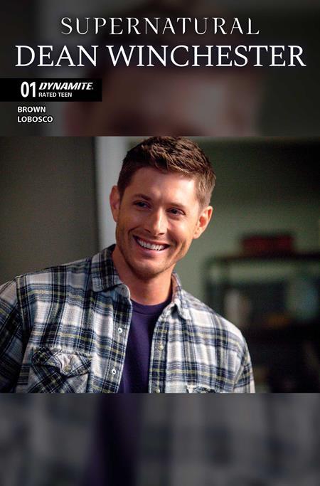 A comic book cover for 'Supernatural: Dean Winchester' issue 01, published by Dynamite. The top portion features the title in white text on a black background, and the bottom portion shows a portrait of a smiling man with brown hair wearing a blue and white plaid button-up shirt over a dark purple t-shirt.