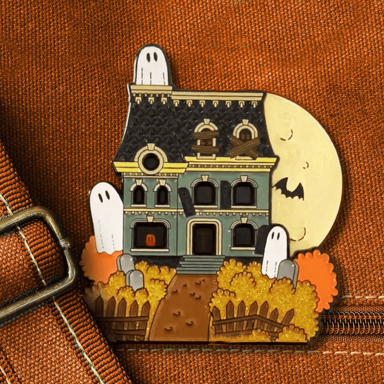 An animated image of an enamel depicting a haunted house, with the moon rising and lowering behind it