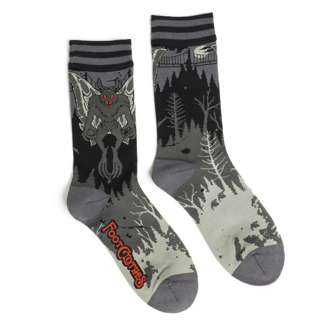 Two socks with wolf designs on a white background