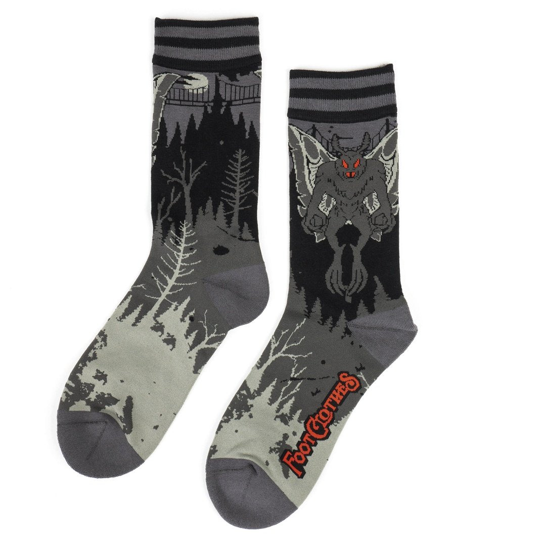 Two socks with wolf and forest design on a white background