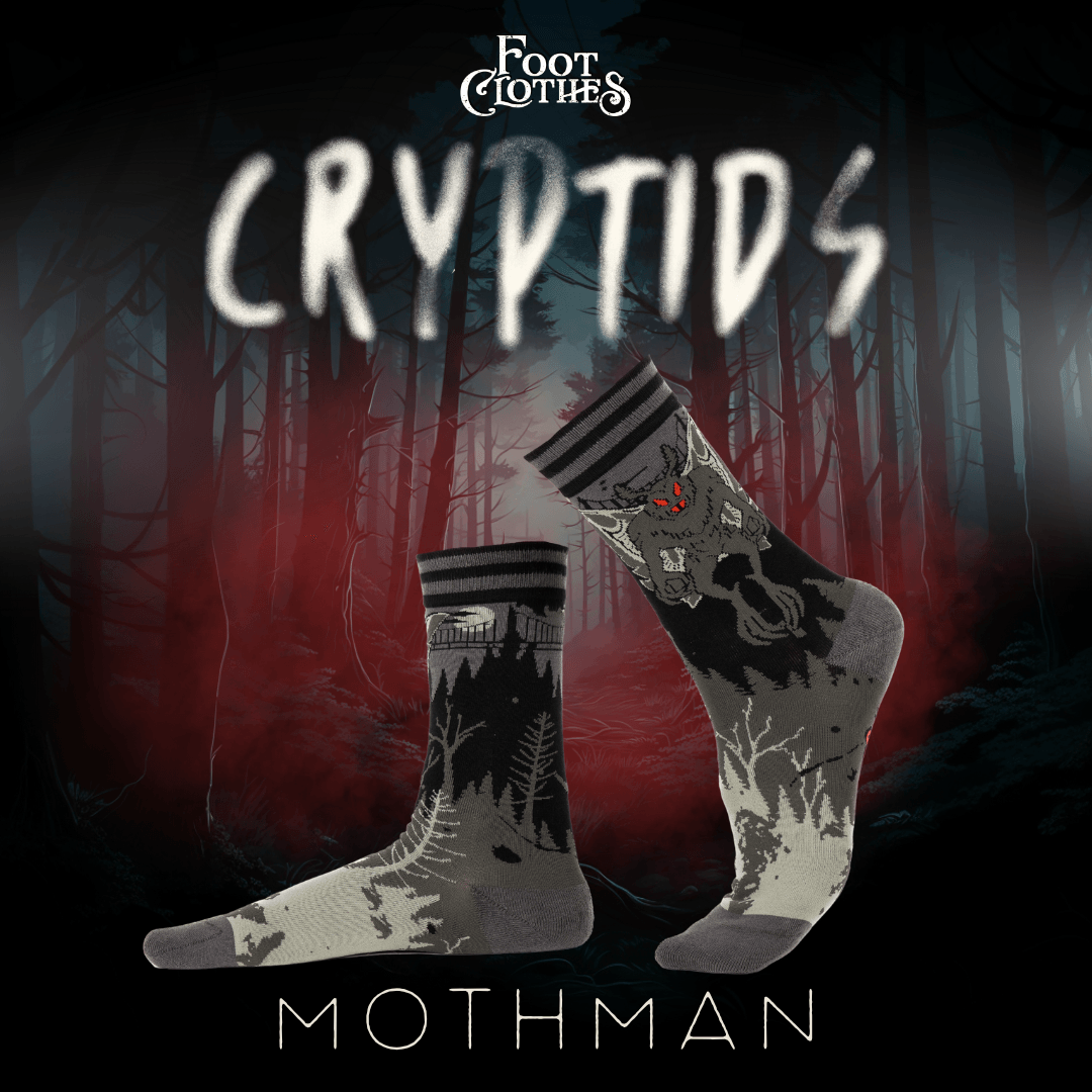 Two socks with Mothman design against a dark forest background, featuring the brand 'Foot Clothes'.